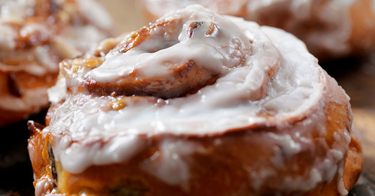 image of sourdough cinnamon roll with cream cheese frosting.
