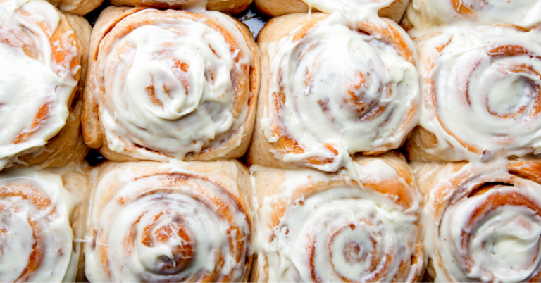 image of sourdough cinnamon rolls on a baking sheet.